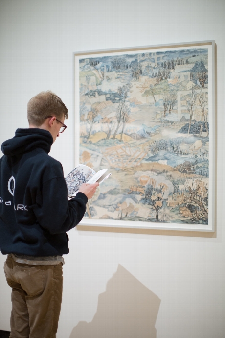  Hamilton student Sawyer Konys '16 reads the Chinese to English translation while viewing work by Yun-Fei Ji
© Janelle Rodriguez