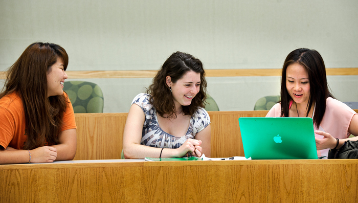 Meghan O'Sullivan '15, center, works with refugees Hnin Ko, from Thailand, left, and Pawser Soe, from Burma, in Kirner-Johnson.